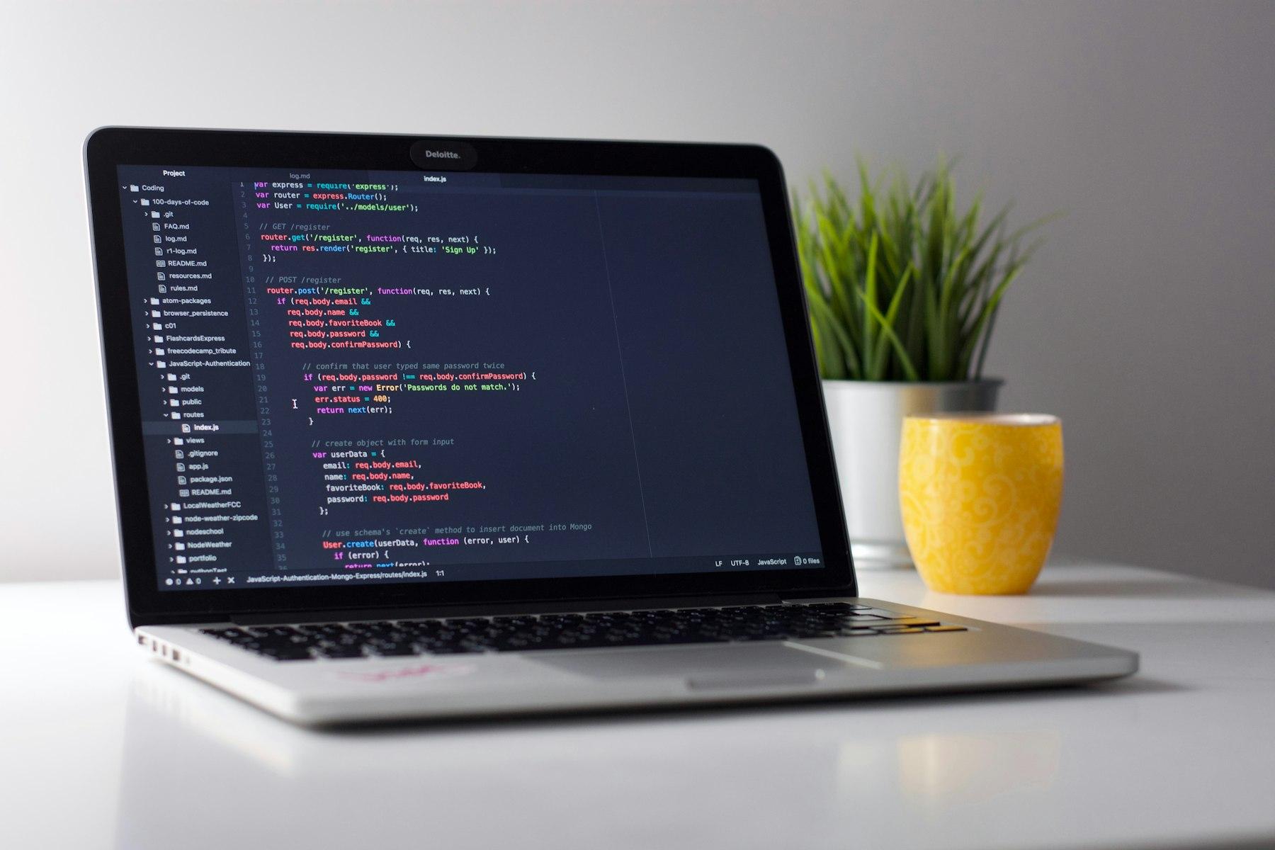 Engineer reviewing code on a laptop